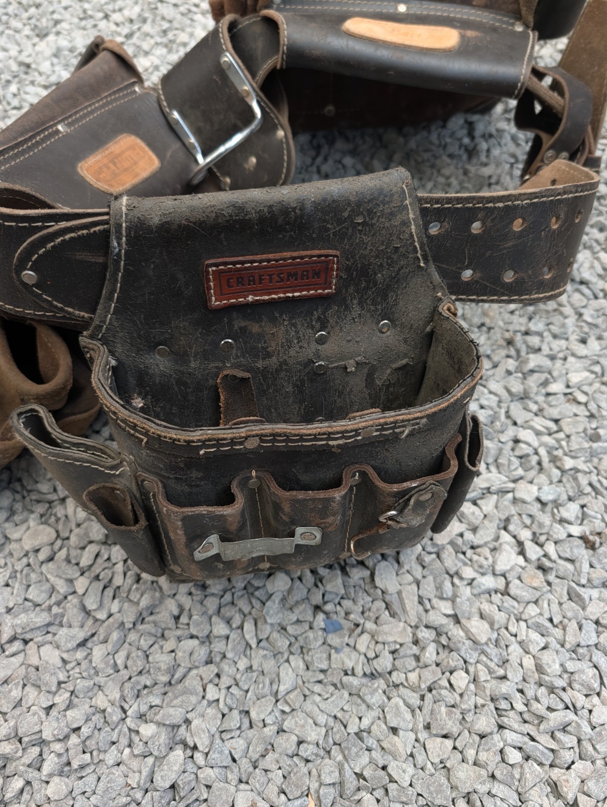 AWP HP brand carpentry tool belt featuring two pouches and one Craftsman pouch.