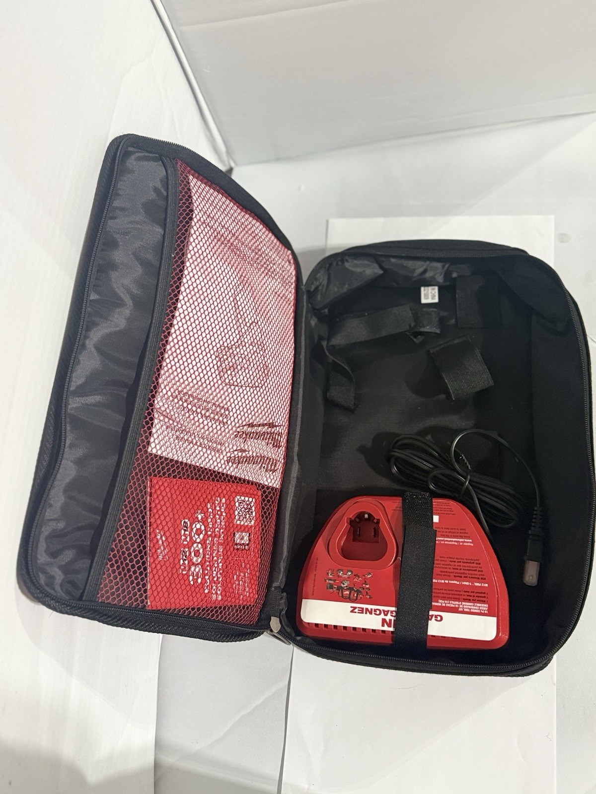 Milwaukee M12 Fuel Zippered Fabric Tool Bag w/ M12 charger and carrying bag.