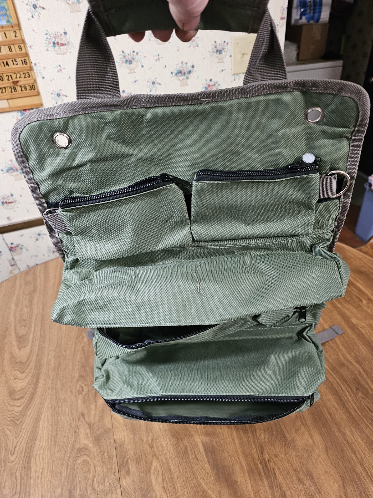 Tool Bag With 7 Pockets Olive green with straps and shoulder strap.